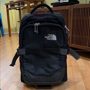 The North Face Black and Gray Men's rolling suitcase.